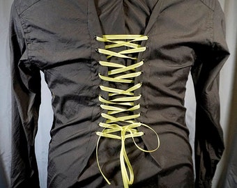 May include: Black long-sleeved shirt with a green ribbon laced up the back.