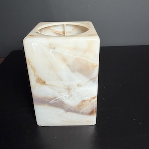 May include: A rectangular lamp shade featuring a marbled pattern with swirls of cream, white, and light brown. The shade has a smooth, semi-translucent finish and a circular opening at the top, showcasing a clean, modern, and functional design.