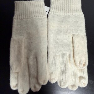 May include: A pair of ivory-colored knitted gloves. The gloves have a ribbed cuff and a separate section for each finger. The material appears to be a soft, warm knit, suitable for cold weather.