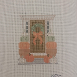Op de afbeelding: Kruissteekontwerp van een voordeur versierd voor de herfst. De deur heeft een groene krans met een perzikkleurige strik. Stapels pompoenen en kalebassen flankeren de deur. De initialen "sSc" staan in de rechter benedenhoek.