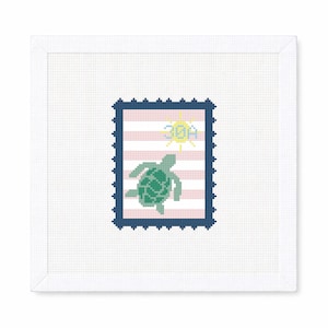 May include: A square, white framed needlepoint featuring a postage stamp design. The stamp has a navy blue border, pink and white stripes, a green turtle, and a yellow sun with the text "30A".