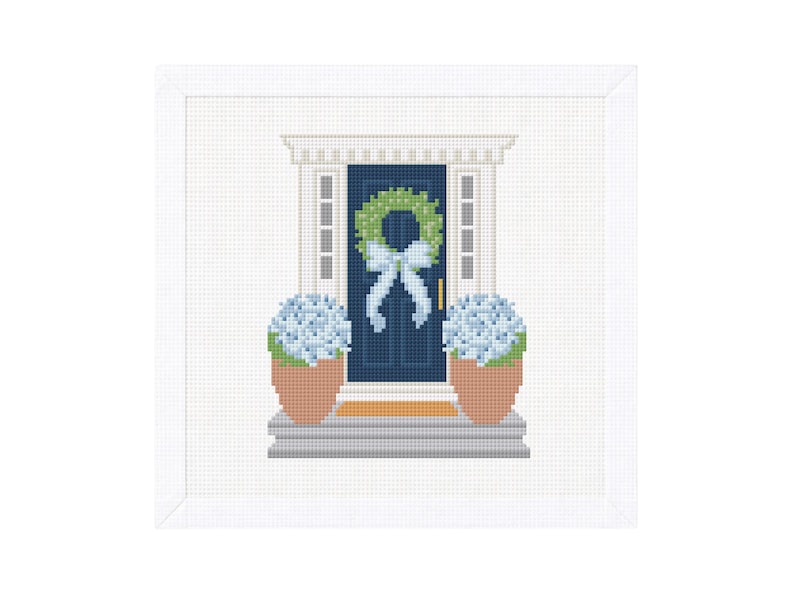 May include: A cross-stitch image of a navy blue front door with a green wreath and a light blue bow. Two potted blue hydrangeas flank the door. The door is framed by white trim and a white background.