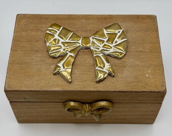 wooden box vintage style with a golden bow on top.