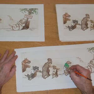 May include: Artwork of anthropomorphic dogs in various poses, some wearing clothes. One dog is leaning against a tree with a "PRIVE" sign. The artwork is on paper, with a person's hand holding a paintbrush, suggesting the art is being worked on.