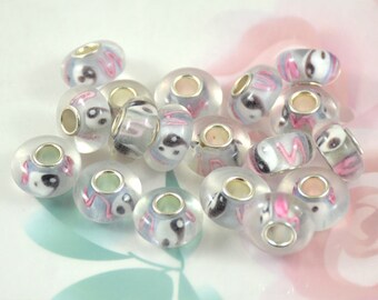 May include: A collection of 15 clear glass beads with a yin yang design and pink accents. The beads have a silver metal core and are designed for use in jewellery making.