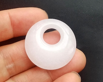 May include: White jade pendant with a round shape and a hole in the center. The pendant is smooth and polished.