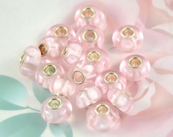 May include: A group of 15 pink glass beads with silver metal accents. The beads are round and have a smooth, glossy finish.