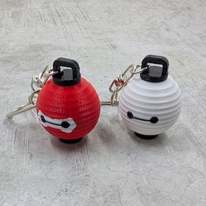 May include: A set of three ceramic mugs with a speckled, matte finish. The mugs are in shades of cream, light gray, and dark gray. Each mug has a simple, minimalist design and a rounded handle.