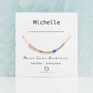 May include: Gold filled and sterling silver Morse code necklace with colorful beads spelling out the name "Michelle".