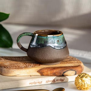 Mugg i mörk stengods med guldkant, handgjord rustik kaffekopp med droppglasyr, Wabi Sabi keramik