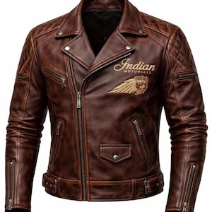 May include: A brown leather motorcycle jacket featuring a diagonal front zipper, quilted shoulder panels, and zippered cuffs. The chest displays an embroidered Indian Motorcycle logo with a feathered headdress emblem in gold and brown tones.