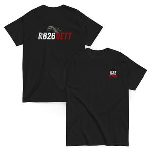 May include: Two black t-shirts. One displays "RB26 DETT" with a Godzilla graphic. The other has "R32 SKYLINE" printed on the front. Both are short-sleeved.