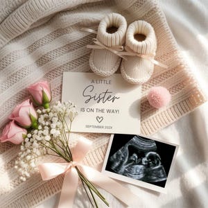 May include: A baby announcement featuring cream-colored knitted baby booties with ribbon ties, a bouquet of pink roses and baby's breath, and a card that reads "A Little Sister Is On The Way!" with a sonogram image.