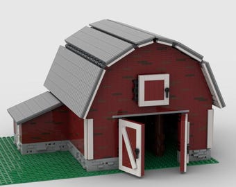 May include: A red brick barn model with a gray corrugated metal roof and white trim. The barn doors are open, revealing a green interior. The model sits on a green base, resembling a field.