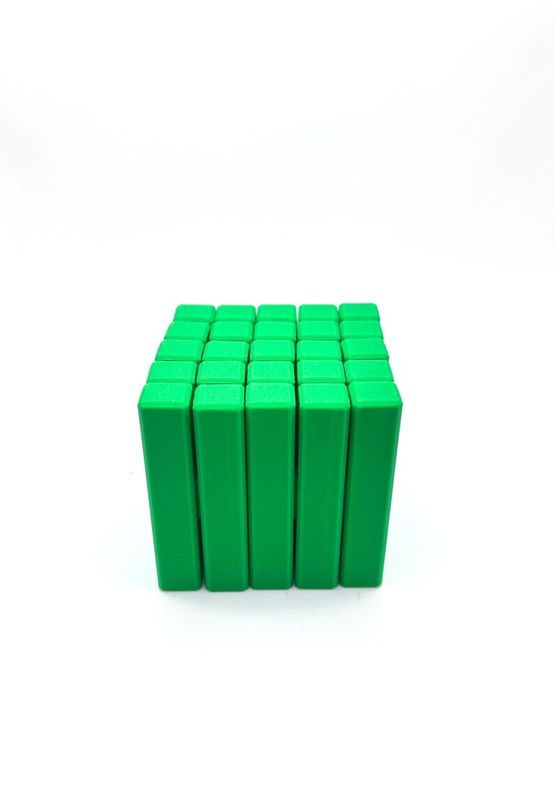 May include: A cube composed of numerous bright green rectangular blocks. The blocks are arranged in a grid pattern, creating a three-dimensional structure. The image is set against a plain white background.