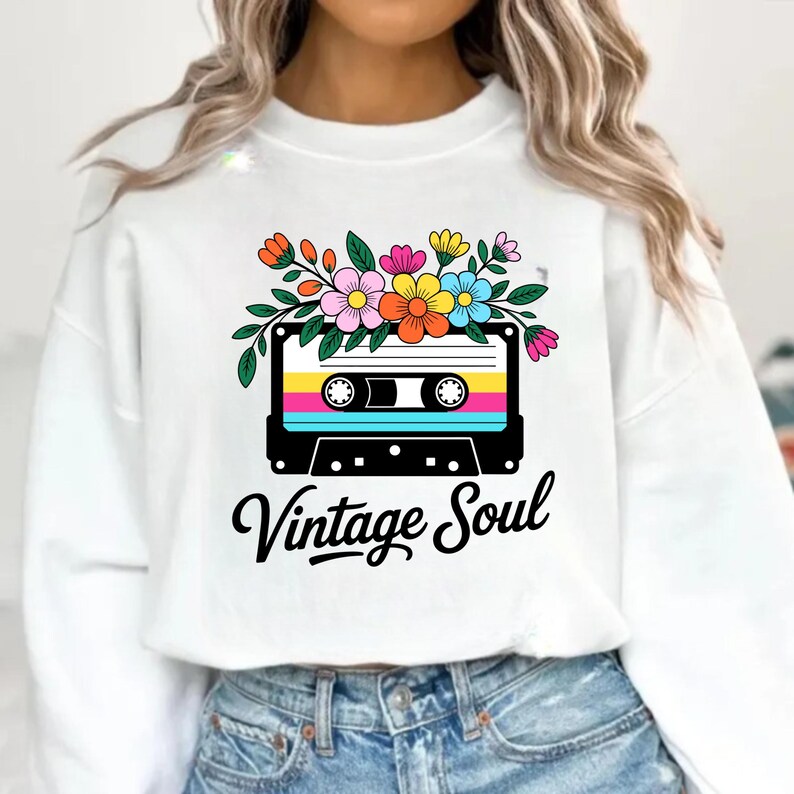May include: White sweatshirt with a retro cassette tape design, adorned with flowers and the words "Vintage Soul". The cassette tape design features bright colours and a floral arrangement.