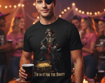 May include: Black t-shirt featuring a pirate skeleton design with the text "I'M IN IT FOR THE BOOTY". The pirate is standing on a treasure chest. The image is set at a Halloween party.