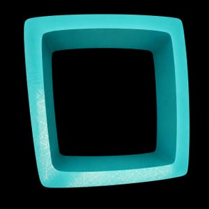 May include: A square-shaped silicone mold in a vibrant turquoise color. The frame features a smooth, matte finish with a subtle, etched geometric pattern of intersecting lines visible along the bottom and left edges of the thick border.