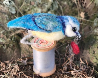 Needle felted blue tit on a vintage thread spool figure, ornament
