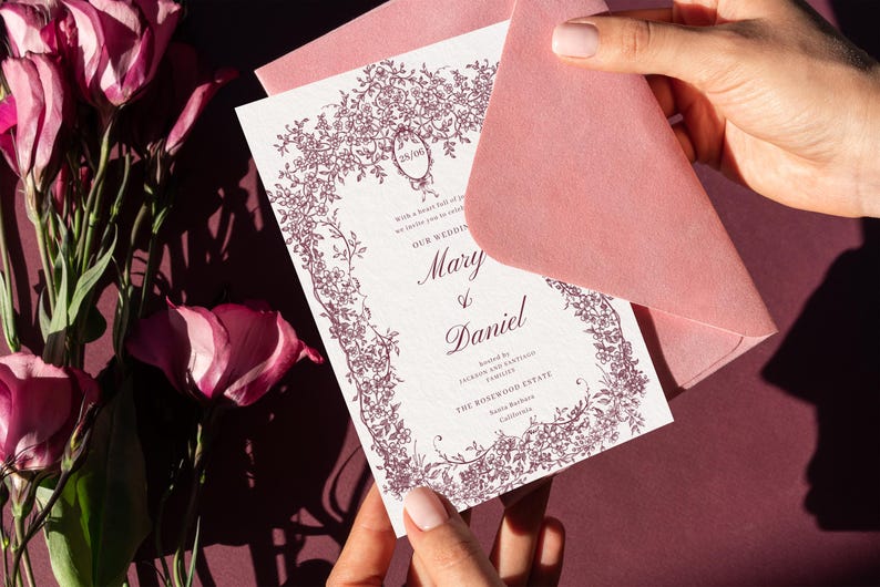 Elegant Victorian wedding invitation card with pink envelope and royal crest design