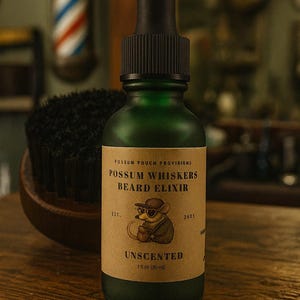 May include: A green glass bottle of Possum Whiskers Beard Elixir with a black dropper. The label features a cartoon possum and the text "Unscented". The bottle is 1 fl oz (30 ml).