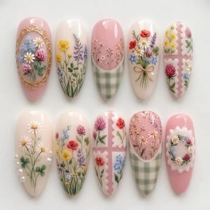 May include: A set of ten artificial nails, each with a unique floral design. The nails feature a variety of flowers in shades of pink, white, yellow, and blue, with some designs incorporating a gingham pattern.