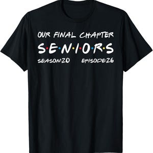 May include: Black t-shirt with white text that reads "OUR FINAL CHAPTER SENIORS" in a colorful, stylized font. Below the text are the words "SEASON:20" and "EPISODE:26". The shirt is a classic crew neck style.