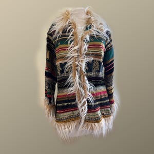 May include: A long, multi-colored coat with a faux fur trim and collar. The coat features a striped pattern in various colors, including black, green, red, and gold. The faux fur is a light brown color.