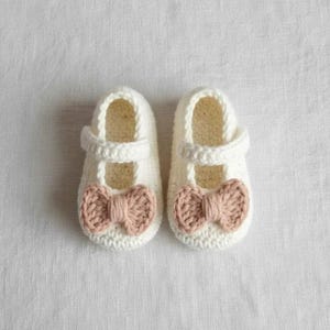 Soft crochet baby shoes beige with brown bow accents, handmade wool booties for newborns, perfect baby shower present.