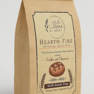 以下が含まれることがあります： Hearth-Fireの職人技のパンミックスが入った茶色の紙袋。ラベルにはMama Bakerのロゴ、「The Bread everyone's been talking about」の文字、「Bake at Home」が記載されています。バッグには「100％グルテンフリー、常に本物の材料」とも書かれています。