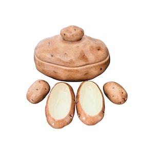 May include: A ceramic potato-shaped lidded container with a glossy tan exterior featuring dark brown speckles. The set includes two smaller open potato-shaped bowls with cream-colored interiors and two solid potato-shaped decorative pieces.