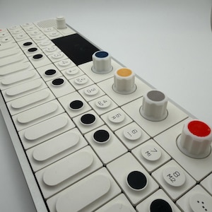 Peut inclure: Synthétiseur de musique électronique blanc avec une série de touches blanches et de boutons circulaires noirs. Il comporte plusieurs boutons colorés, dont bleu, jaune, gris et rouge. L'appareil dispose d'un haut-parleur intégré et d'un petit écran noir.