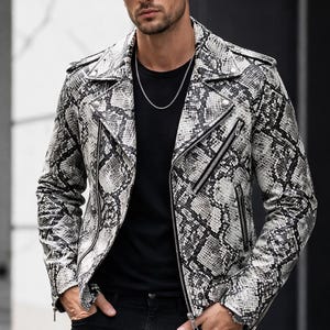 May include: A black and white snakeskin-patterned leather jacket with multiple zippers. The jacket is worn over a black t-shirt and paired with black jeans. The person is wearing sunglasses and a silver chain.