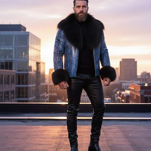 May include: A blue snakeskin-patterned jacket with a black fur collar and cuffs. The jacket is worn over a black turtleneck and paired with black leather pants and boots. The background features a cityscape at sunset.