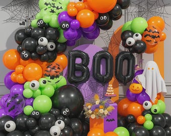 May include: A festive Halloween balloon arch with black, orange, green, and purple balloons. The word "BOO" is spelled out in black balloons. Includes spider webs, a ghost, and a pumpkin.