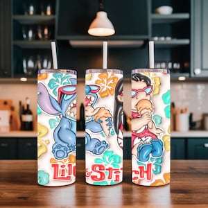 May include: Three stainless steel tumblers with white straws. Each tumbler features a colorful cartoon design of characters from the movie "Lilo & Stitch", with the words "Lilo & Stitch" in red and white. The background includes floral and tropical elements.