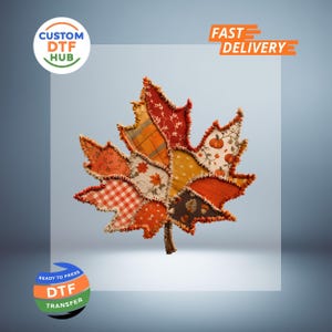 May include: A decorative maple leaf shape constructed from various fabric patches with frayed edges. The patches feature autumn-themed patterns including orange plaid, white and red gingham, pumpkins, and acorns in shades of red, orange, and yellow.