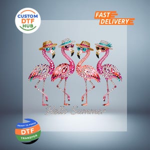 May include: A DTF transfer design featuring four pink flamingoes adorned with sparkling embellishments, sunglasses, and hats. The phrase "Hello Summer" is written in silver script below the birds. The image includes the text "Custom DTF Hub" and "Fast Delivery".