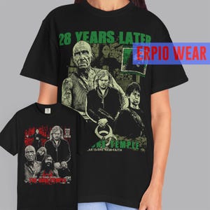 May include: Black t-shirt featuring a graphic design with the text "28 YEARS LATER" and "THE TEMPLE". The design includes images of several people. A smaller t-shirt with a similar design is also visible.