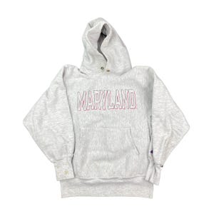 May include: A grey Champion hoodie with the word "MARYLAND" in red and white lettering on the front.