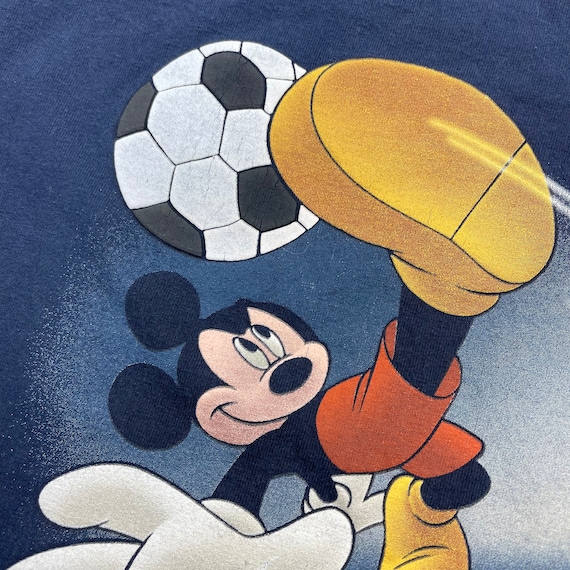 Good looking mickey mouse wearing a real madrid football kit