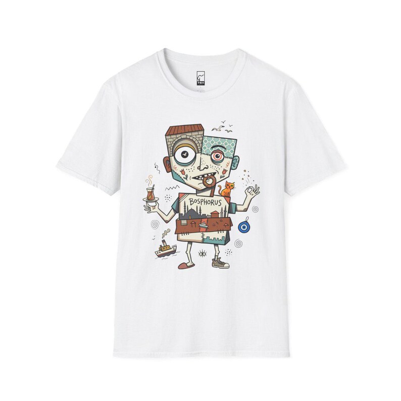 May include: White t-shirt featuring a whimsical cartoon character with a Bosphorus design. The character holds a tea cup and a cat, with a boat and an evil eye symbol. The design incorporates various colors and patterns.