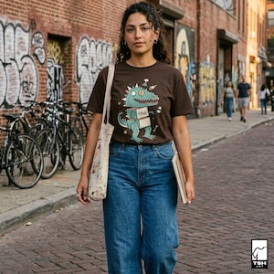 May include: A brown t-shirt featuring a cartoon dinosaur with the word "RAWR" on its chest. The dinosaur is light blue with green accents. The person is wearing blue jeans and carrying a tote bag and a notebook.