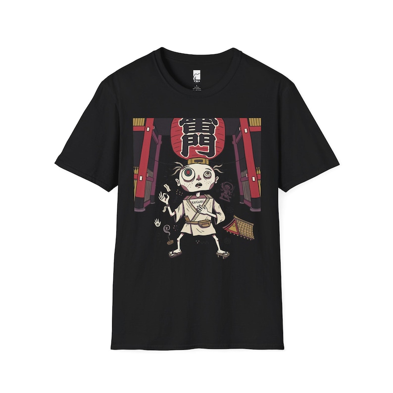 May include: A black short-sleeve t-shirt featuring a graphic print of a stylized character in traditional Japanese attire standing beneath a large red lantern with the kanji characters 雷門. The design includes architectural elements and small icons.
