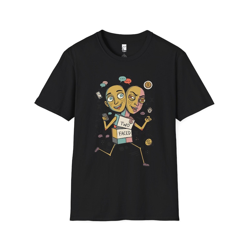 May include: A black short-sleeve t-shirt featuring a graphic of a two-headed character with a box-shaped torso labeled TWO FACED. The illustration includes speech bubbles, a smartphone, and small icons surrounding the character on the chest.