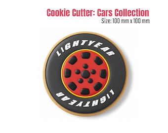 May include: A cookie cutter in the shape of a Lightyear tire, part of the Cars Collection. The tire is black with a red center and yellow accents. The text "LIGHTYEAR" is in white. The cutter measures 100 mm x 100 mm.