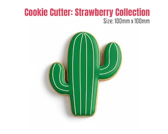 May include: A green cactus-shaped cookie cutter with white accent lines. The cookie cutter is part of the "Strawberry Collection" and measures 100mm x 100mm.