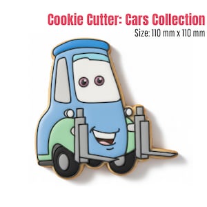 May include: A cookie cutter in the shape of a cartoon forklift truck. The cookie cutter is blue, green, and white with black wheels and a smiling face. The text "Cookie Cutter: Cars Collection" is at the top.