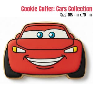 May include: A red car-shaped cookie cutter from the Cars Collection. The cutter features a smiling car face with blue eyes, white highlights, and black tires. The cookie cutter measures 105 mm x 70 mm.
