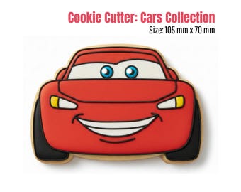 May include: A red car-shaped cookie cutter from the Cars Collection. The cutter features a smiling car face with blue eyes, white highlights, and black tires. The cookie cutter measures 105 mm x 70 mm.